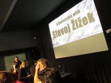 Slavoj Žižek covering his eyes the evening of Donald J Trump's early morning victory over Hillary Clinton